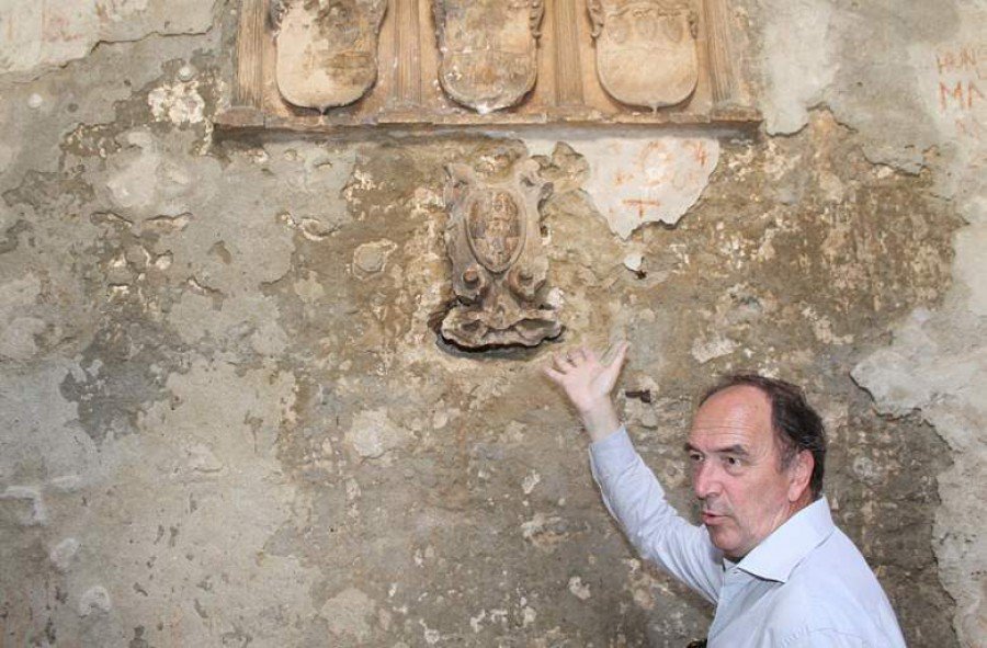 Josip Belamarić pokazuje mletački grb čija kojeg je nepoznati počititelj oštetio pokušavajući ga skinuti zajedno s kamenim blokom u koji je ukleasan (Foto H. Pavić)